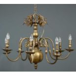 A Flemish eight light brass chandelier, with central baluster column headed by eight removable