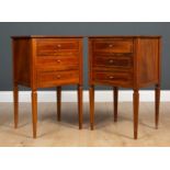 A pair of mahogany satinwood inlaid bedside cabinets of three drawers on tapering square supports