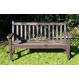 A brown painted two seater hardwood garden bench by Lister Dursley Glos, with shaped arms, 153cm