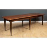 A 19th century French stained pine rectangular table with six square tapering legs, 258cm in