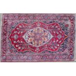 A late 20th century Middle Eastern red ground carpet 319cm x 222cmCondition report: Considerable