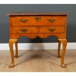 A George III and later walnut lowboy the burrwood top with boxwood stringing over three drawers