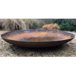 A large spun steel fire bowl, approximately 120cm diameter x 24cm highCondition report: Rusted but
