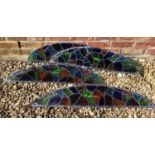 Four 20th century leaded stained glass panels of arching form, each 87cm wide x 26cm highCondition