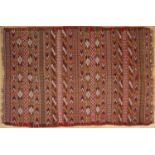 A Quchan Kelim rug with a red ground with striped and geometric decoration, 230cm x 145cm From the
