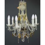 A cut glass six branch chandelier with two layers of trailing cut glass clear and amber coloured