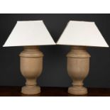 A pair of table lamps the bases formed as turned wooden urns, on circular plinth base, 48cm high