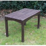 A brown painted hardwood garden table on chamfered supports, 122cm wide x 68.5cm deep x 71cm