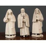 Three Elizabethian style plaster figures, two of veiled women, the third of a bearded man,