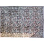 A white ground rug with bird, floral and foliate decoration, within green floral motif border, 342cm