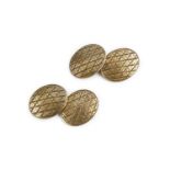 A pair of cufflinks, each oval panel with engraved lattice decoration, on figure-of-eight