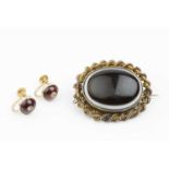 A Victorian banded agate memorial brooch, the oval banded agate cabochon within a ropetwist