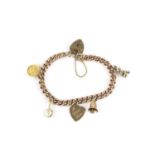 A charm bracelet, the 9ct gold curb-link bracelet with padlock clasp, suspending a small