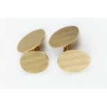 A pair of 9ct gold cufflinks, the oval panels with engine-turned decoration, on chain-link fittings,