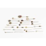 A collection of antique and later stick pins, comprising a diamond circlet stick pin, a diamond