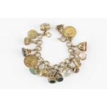 A charm bracelet, the 9ct gold fancy-link bracelet with alternate ropetwist and polished hoop-shaped