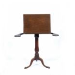 A Victorian mahogany music stand the rest adjusting on a ratchet and with swivel fold out candle