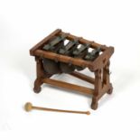 An early 20th century musical bell chime xylophone with four copper and brass bells of flattened