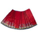 Embroidered red ground silk skirt Chinese, 19th Century decorated in various panels depicting five-