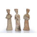 Three unglazed earthenware tomb figures in the form of musicians Chinese, Tang period each woman