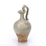 White glazed 'Dragon handle' ewer Chinese, Tang dynasty with two floral medallions in relief on