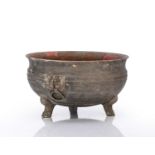 Pottery bowl Chinese, Han dynasty supported by three feet, the body with two Taoti masks on the