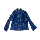 Blue ground jacket Chinese, 20th Century decorated with embroidered flowers to the exterior, with