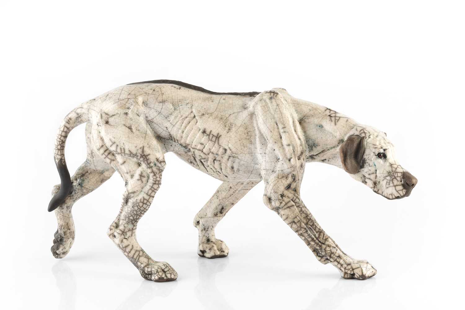 Keza Rudge (20th Century) Model of a hound raku signed 40cm across.Crazing to the glaze all over.