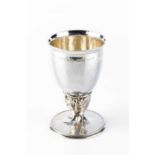 Omar Ramsden (1873-1939) A silver chalice, 1927 with planished body, the stem decorated in relief