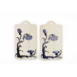 Art Nouveau A pair of wall tiles painted with stylised flowers indistinctly signed 23 x 13cm (2).