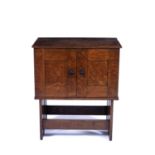 Arts & Crafts Hall cupboard oak with inlaid detail and beaten metal handles, on slatted base 83cm