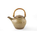 Jim Malone (b.1946) Teapot green ash glaze and incised decoration, with cane handle impressed