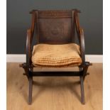 A late 19th century oak Glastonbury chair with carved inscriptions, 63cm wide x 52cm deep x 47cm