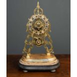 A brass skeleton timepiece, mounted on a painted wooden base, in need of repair and