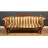 A Regency mahogany high back settee with scrolling arms, turned supports and brass casters, 220cm