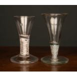 An 18th century ale glass with an opaque twist stem and a large foot, the foot 7cm diameter x 11cm