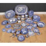 A collection of antique and later Staffordshire Willow Pattern china to include tureens, a large
