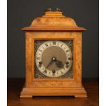 A 1940's Smith's walnut and mahogany cased mantle clock the silvered surround to the metal dial