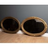 A pair of oval gilt framed wall mirrors each 67cm x 89cm together with a dressing table mirror