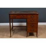 An Edwardian mahoganny writing desk with a leather inset top, 5 drawers with brass swan neck