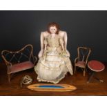 A 20th-century wooden doll in Regency style dress, 53cm high together with a doll's wingback