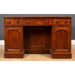 A late Victorian mahogany knee hole pedestal desk with three drawers, two panelled doors and