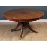 A Victorian burr walnut tilt top table on turned column and three scrolling outswept supports and