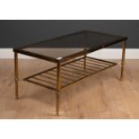 A brass and smoky glass rectangular coffee table, 91cm wide, 46cm deep, 41cm highGood.