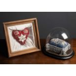 An Elizabeth II Silver Jubilee pin cushion, 14cm x 14cm, mounted in a pine framed case, overall 28cm