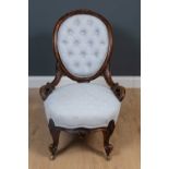 A Victorian upholstered low chair, with brass casters, 60cm wide, 50cm deep, 35cm high at the