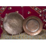 A Persian copper on tin shallow circular dish decorated with three figures, 21cm diameter and an