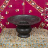 A Malay bronze spittoon with broad rim on baluster stem, 32cm diameter