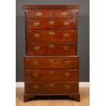 A George III mahogany tallboy, the dentil cornice over two short and six long drawers, with brass