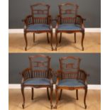 Four similar colonial hardwood elbow chairs with cut out detail to the backs and blue upholstered